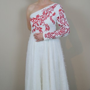 Zoom on the sleeve and hand embroidery on midi wedding dress