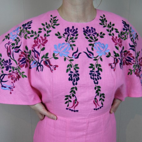 Close-up of hand embroidery on pink French linen dress