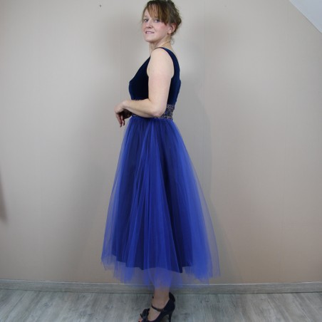 Side view of navy velvet and tulle cocktail dress at calf length