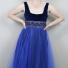 U-shaped neckline of velvet evening dress with lace appliqué and beadwork
