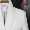 zoom on the fabric of the Casual yet elegant ivory jacket ideal for daytime outings or nuptial events.