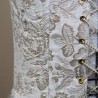 Close-up of the luxurious Victorian brocade fabric showing texture.