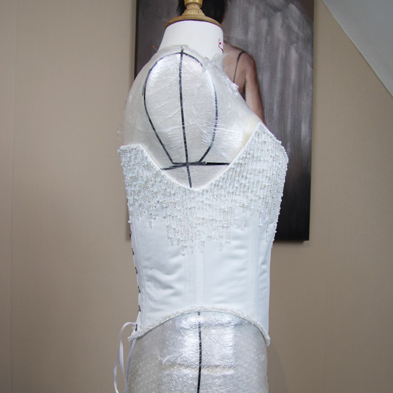 Side view of the bridal corset showing the hand applied beadwork