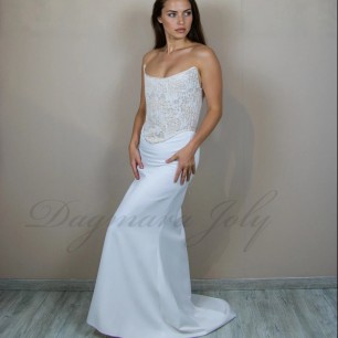 Side view of the bridal set showing the silhouette of the corset and the flowing crepe train skirt,