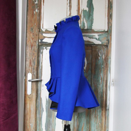 Side profile of asymmetrical peplum jacket highlighting waist structure