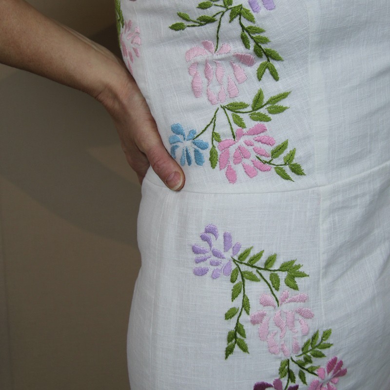 Close-up of floral embroidery on white linen fabric