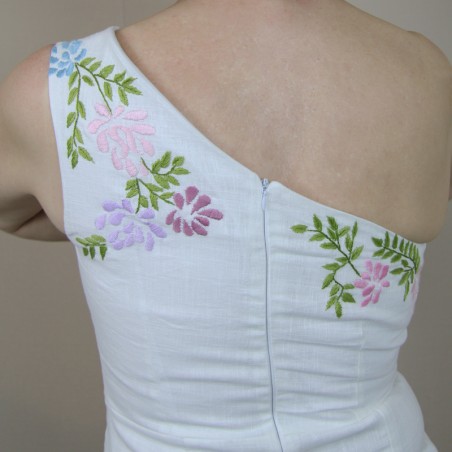 Close-up of floral embroidery on white linen fabric