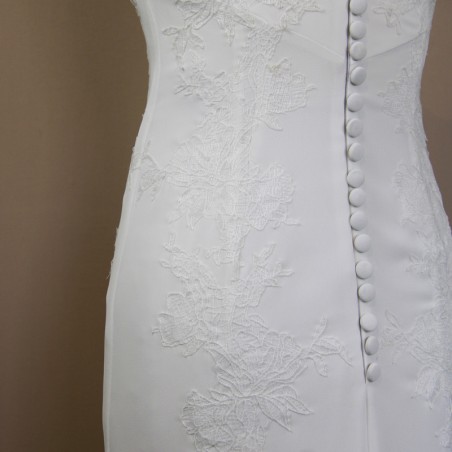 Close-up of hand embellished lace detail on modern crepe wedding gown