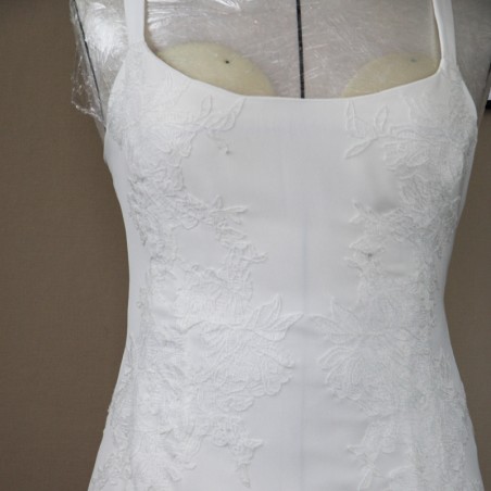 Delicate bridal straps and lace appliqué detail on minimalist wedding gown