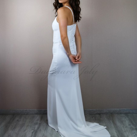 Back view of modern crepe bridal gown with decorative buttons and lace details