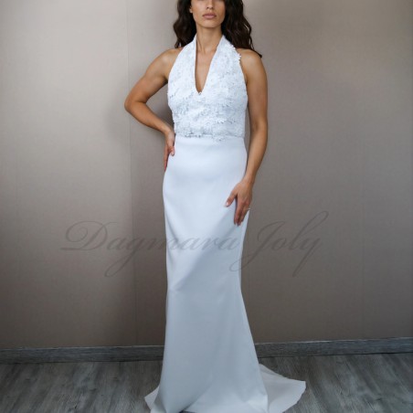 Front view of a minimalist wedding gown with halter neckline and flowing train.