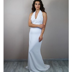 Front profile of a bride in a floor-length sheath lace and crepe wedding dress
