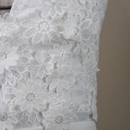 Close-up of hand appliqués of hand applied flowers on a lace of wedding dress.