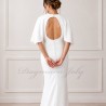 Zoom on the details of the back  of modern crepe bridal gown with decorative buttons and open back