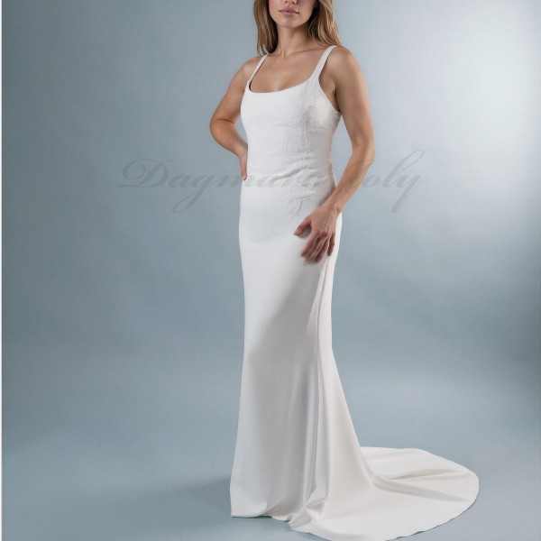 Front view of modern crepe wedding dress with straight cut and elegant short train