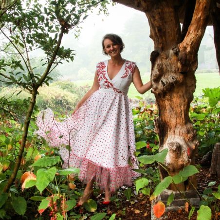 Handcrafted white linen dress with tulle accents, wrap closure and embroidered details