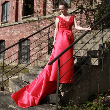 Long red cocktail dress with train and front slit without sleeves