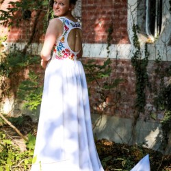 White long sleeveless front slit dress with deep v neckline and open back