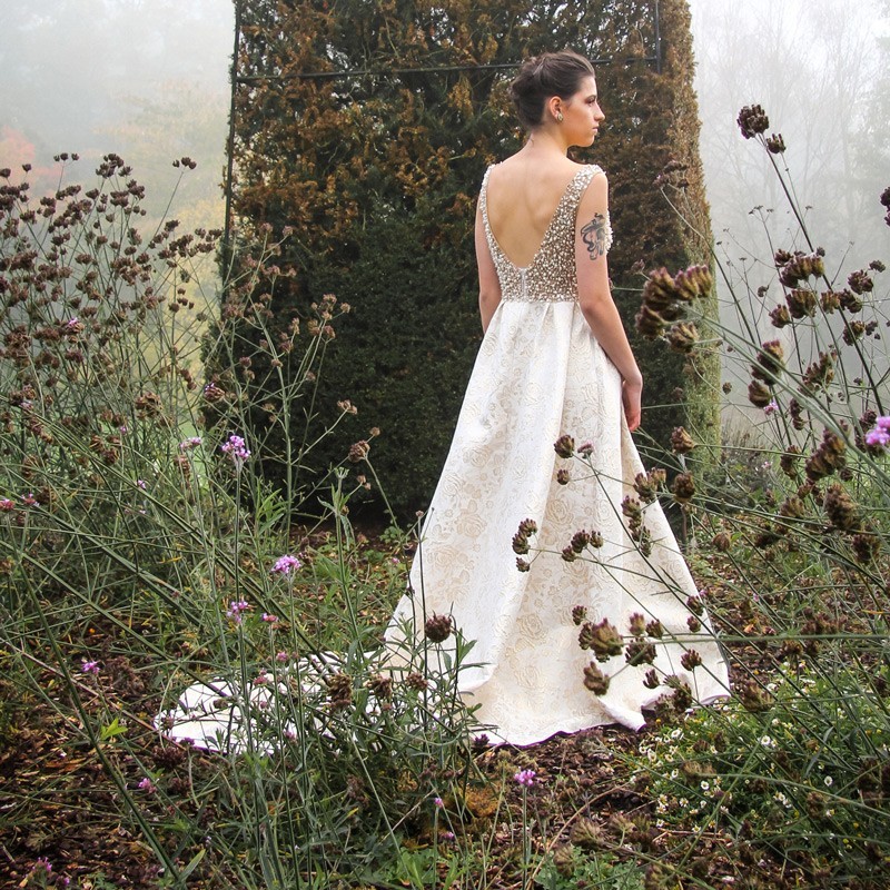 Back view of sleeveless gown with open deep U-back and long train