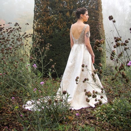 Back view of sleeveless gown with open deep U-back and long train