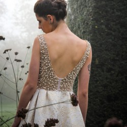 Long sleeveless asymmetrical wedding dress with train