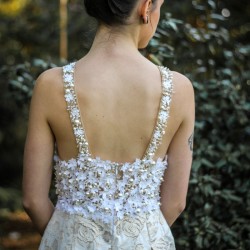Back view showing the minimalist design and delicate hand embellishments.