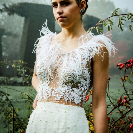 Robe de mariée droite ornée des perles, sans manches, boutonnée dans le dos