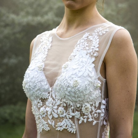 Zoom on the intricate beadwork and fine stitching on the bodice.