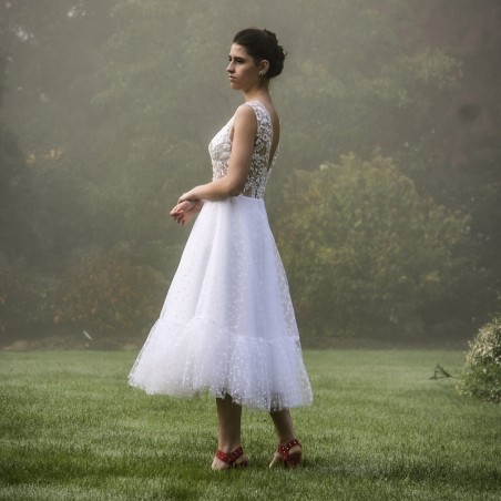 Artistic shot showing the dress in motion, highlighting softness and elegance.