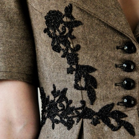 Veste de soirée unique à basque courte, dos ouvert chic et détails artisanaux luxueux.