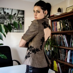 Short evening blazer in glamorous shiny tweed with subtle sparkle, featuring lace, beads, and pearl embellishments.