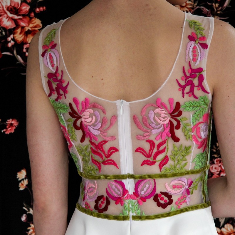 zoom on back view of floral hand embroidery on sleeveless midi dress