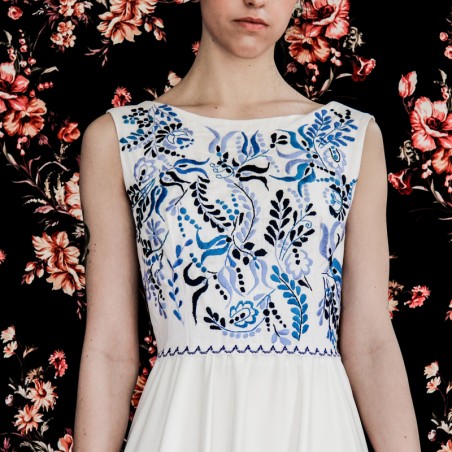 White floor length hand embroidered and sleeveless linen wedding dress.