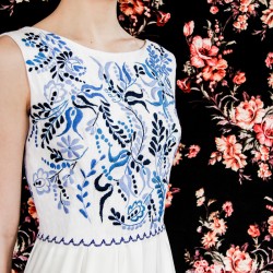 White floor length hand embroidered and sleeveless linen wedding dress.