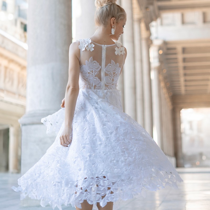 Back of midi lace wedding dress with delicate pearl buttons and floral embellishments, handcrafted in France.