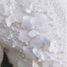 Close-up of the luxurious tweed fabric of a short wedding dress, highlighting texture and detail.