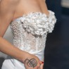 Close-up of hand-embellished pearls, crystals, and flowers on wedding dress bodice