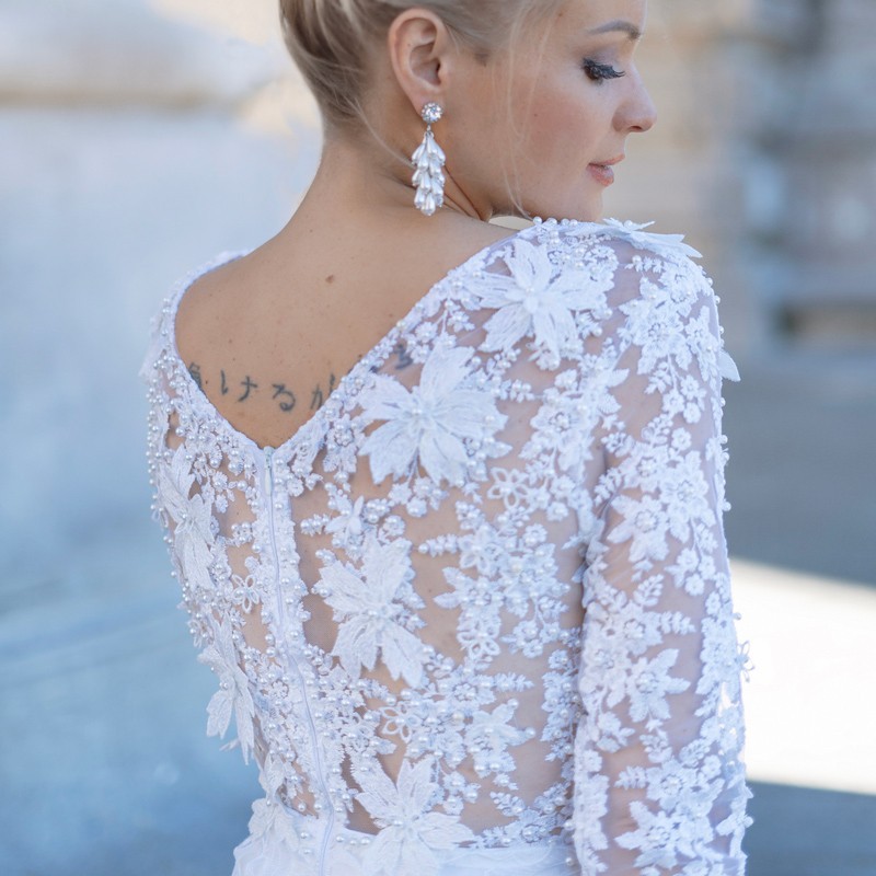 Side view of pencil-style modest wedding dress showing fitted shape and 3/4 lace sleeves