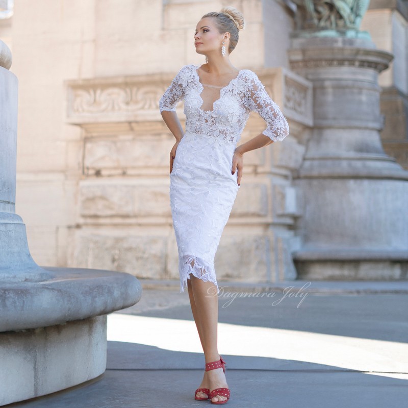 Front of elegant modest wedding dress with lace overlay, fitted pencil silhouette, and delicate floral embellishments