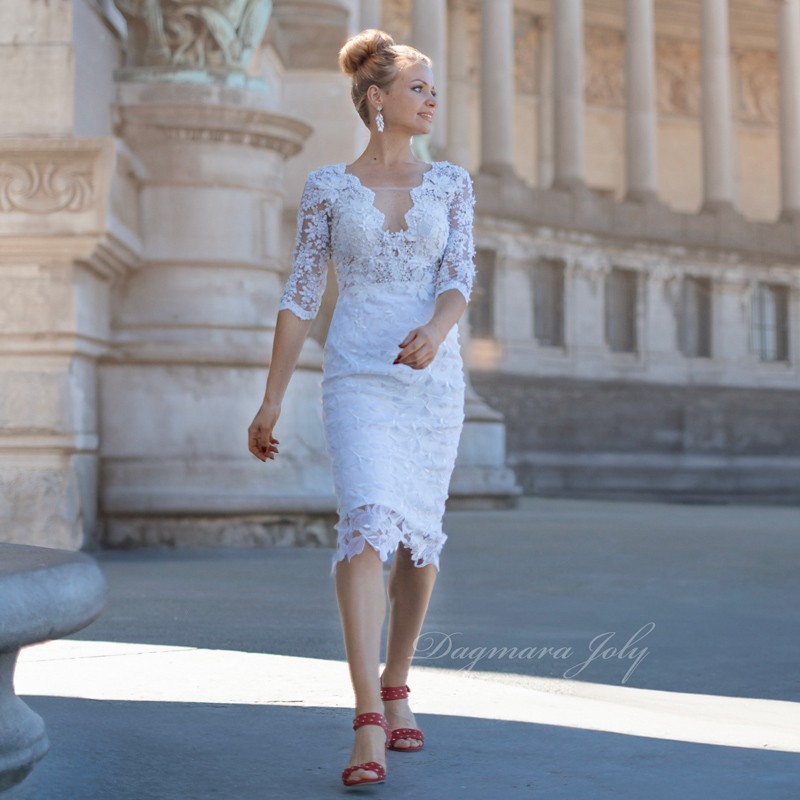 Modest lace wedding dress front view with pencil silhouette, 3/4 sleeves, and floral pearl embellishments