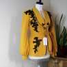 Elegant women’s mustard jacket hand-embellished with black lace – side profile Elegant women’s mustard jacket hand-embellished with black lace – side profile